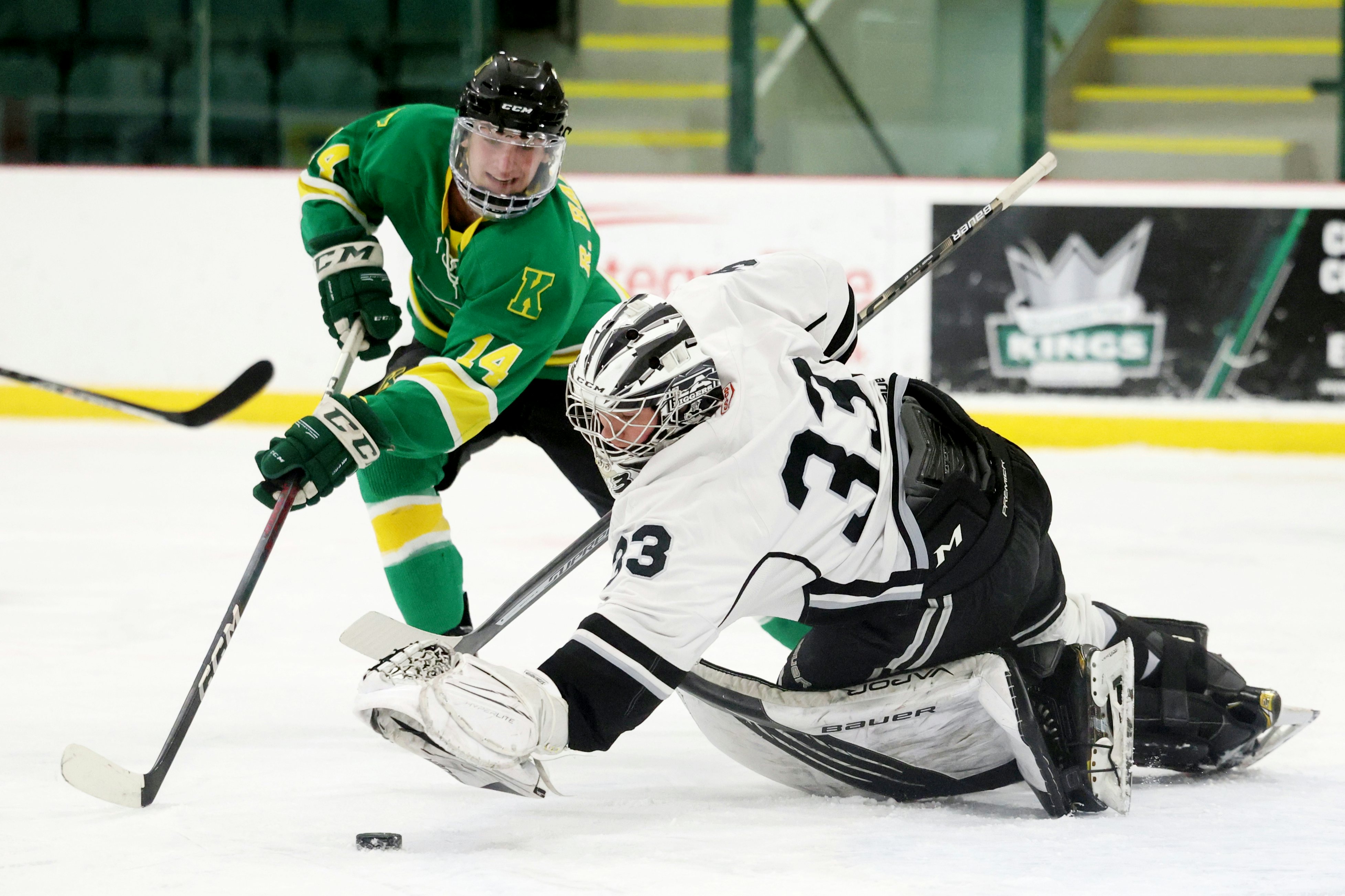 SHERWOOD PARK, AB - October 31: Leduc Riggers goaltender Dayton McGrath #35 lunges over the puck in front of Sherwood Park Knights forward Ryan Bablitz (14) during Capital Junior Hockey League play at Randy Rosen Arena in Sherwood Park, AB on October 31st, 2023. (Photo by James Maclennan)