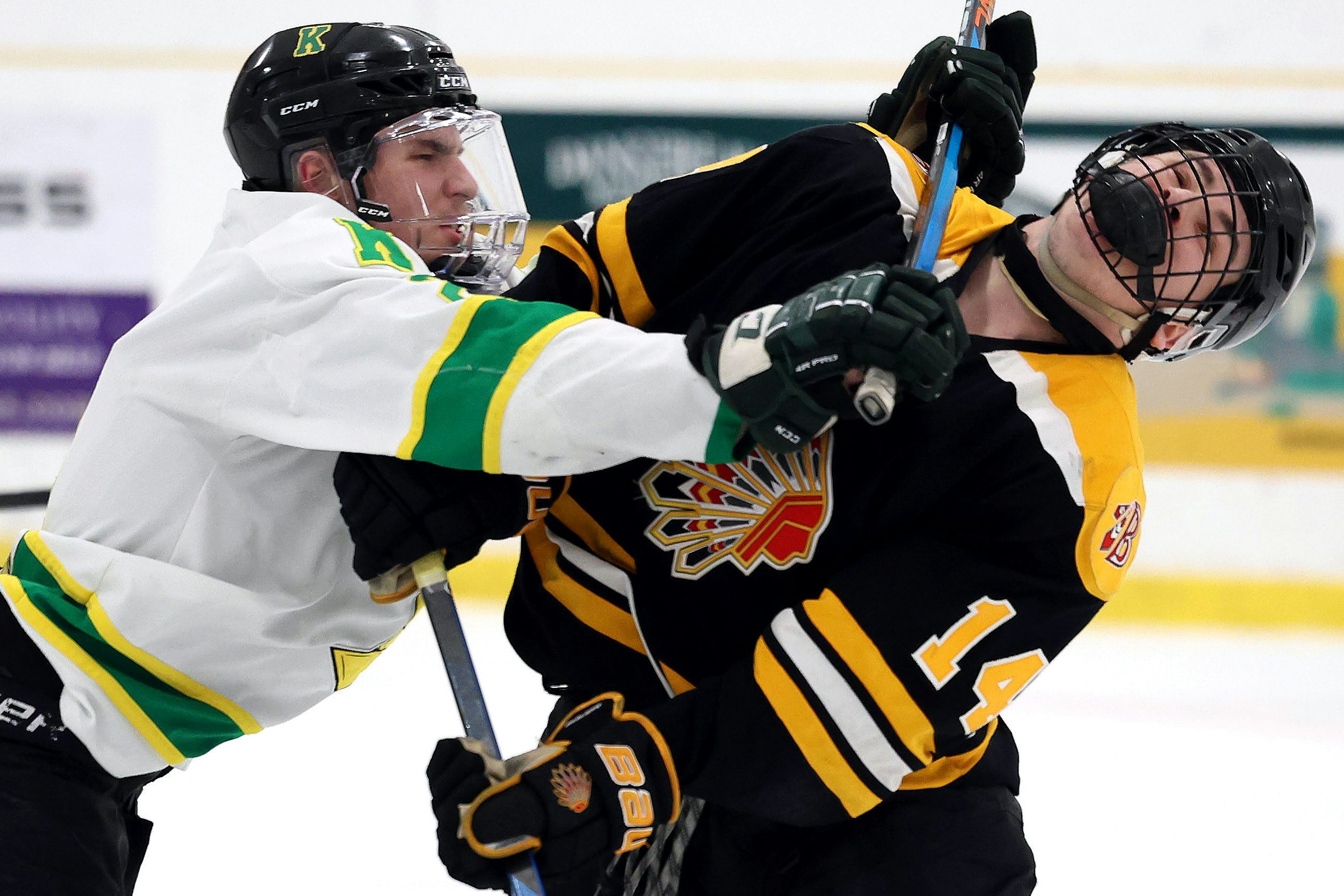 BEAUMONT, AB - March 10: Beaumont Chiefs forward Ashton Mackie #14 is crosschecked by Sherwood Park Knights forward Kaelen Veldman during Capital Junior Hockey League play at the Ken Nichol Regional Recreational Centre in Beaumont, AB on March 10th, 2024. (Photo by James Maclennan)