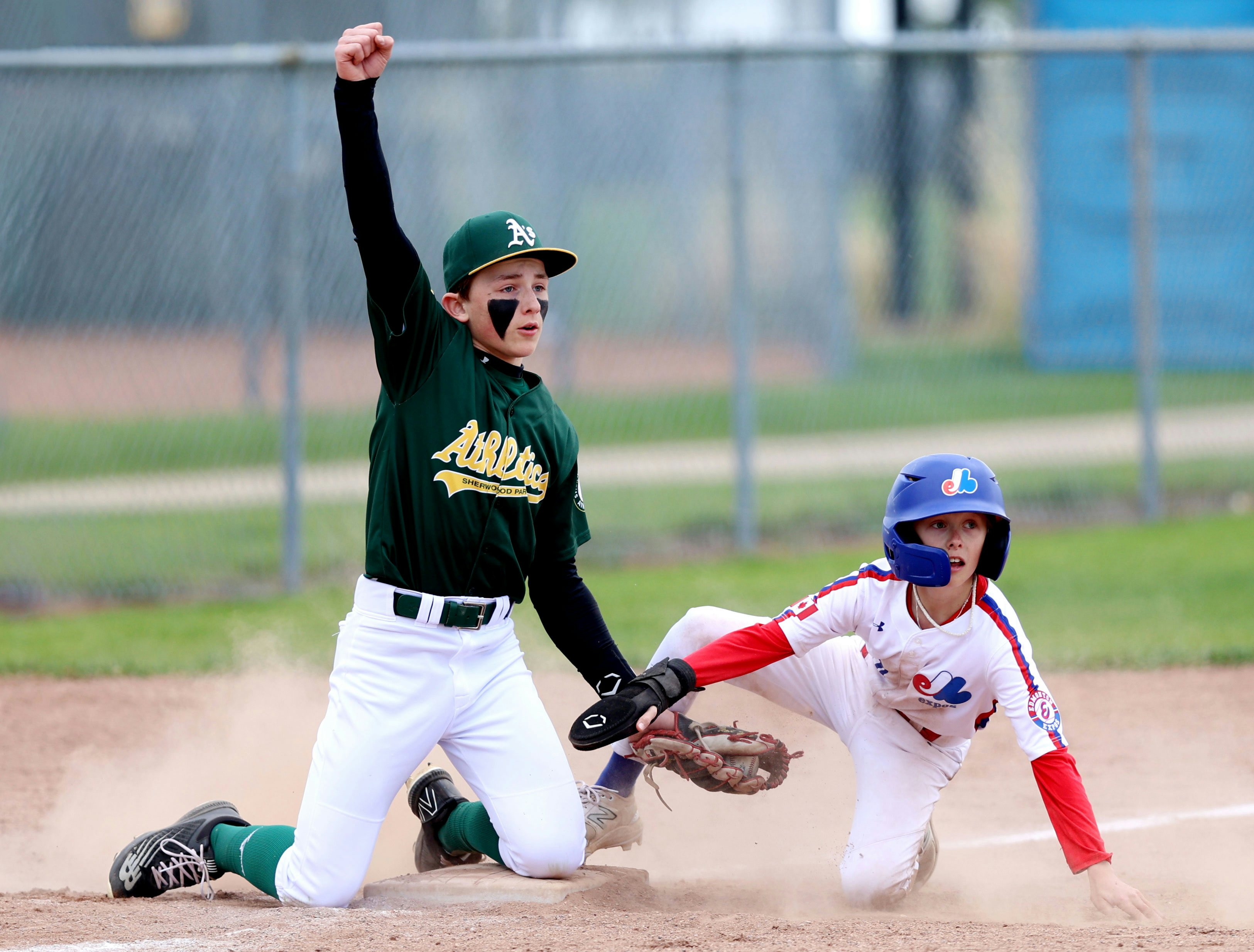 SPRUCE GROVE, AB - May 18: U13 AAA Sherwood Park Athletics 3rd baseman Caleb Poulin reacts after tagging an opponent Henry Singer Ball Park in Spruce Grove, AB on May 22nd, 2024. (Photo by James Maclennan)