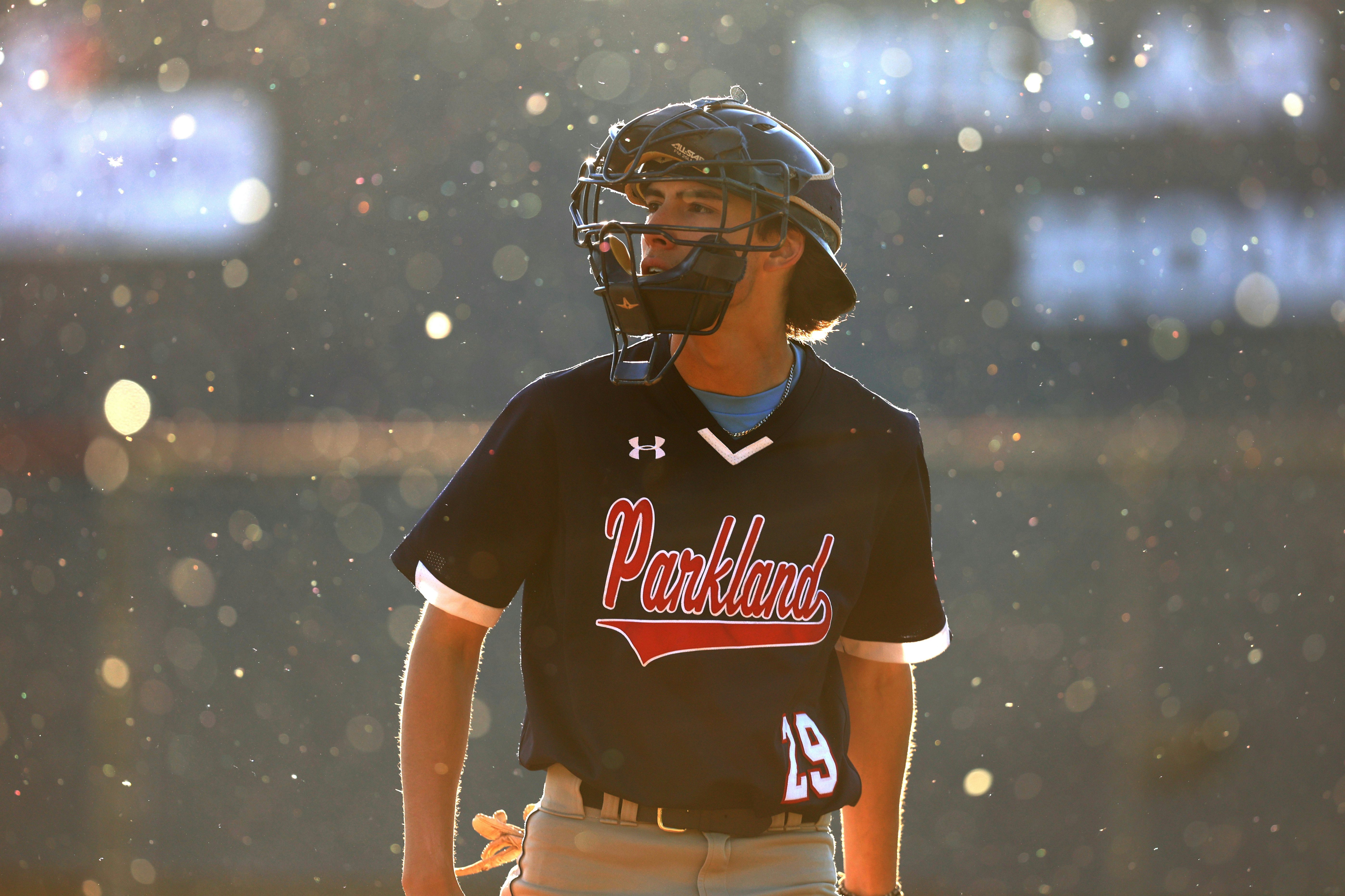 ST. ALBERT, AB - Cottonwood pollen swirls around Parkland Twins catcher CJ Twin during a game against the St. Albert Cardinals at Legion Memorial Park in St. Albert on May 29, 2024.. (Photo by James Maclennan)