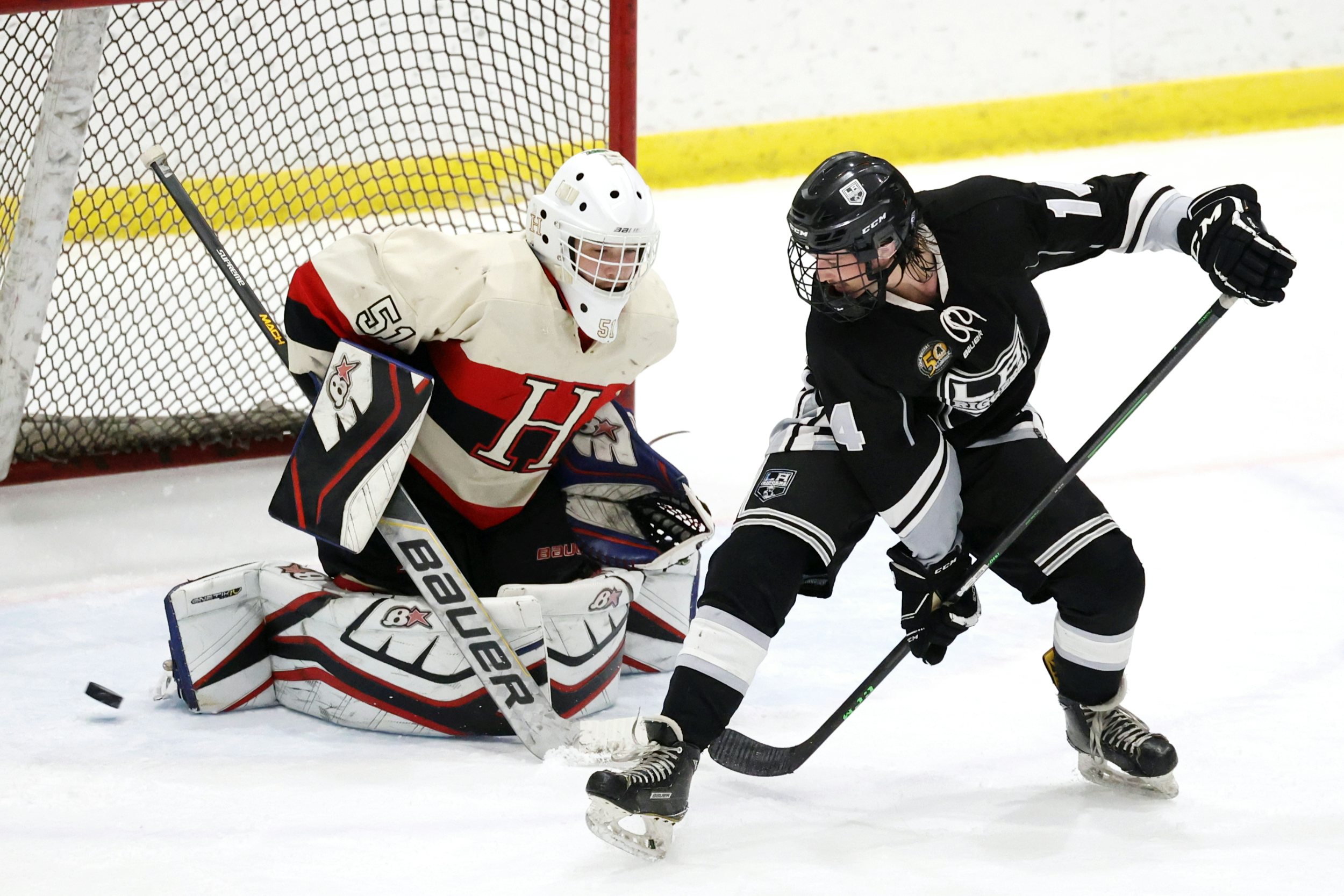 LEDUC, AB - November 4: Leduc Riggers forward Riley Knaus #14 redirects a puck against the Fort Saskatchewan Hawks during Capital Junior Hockey League play at LRC - Co-op Arena on November 4th, 2023. (Photo by James Maclennan)