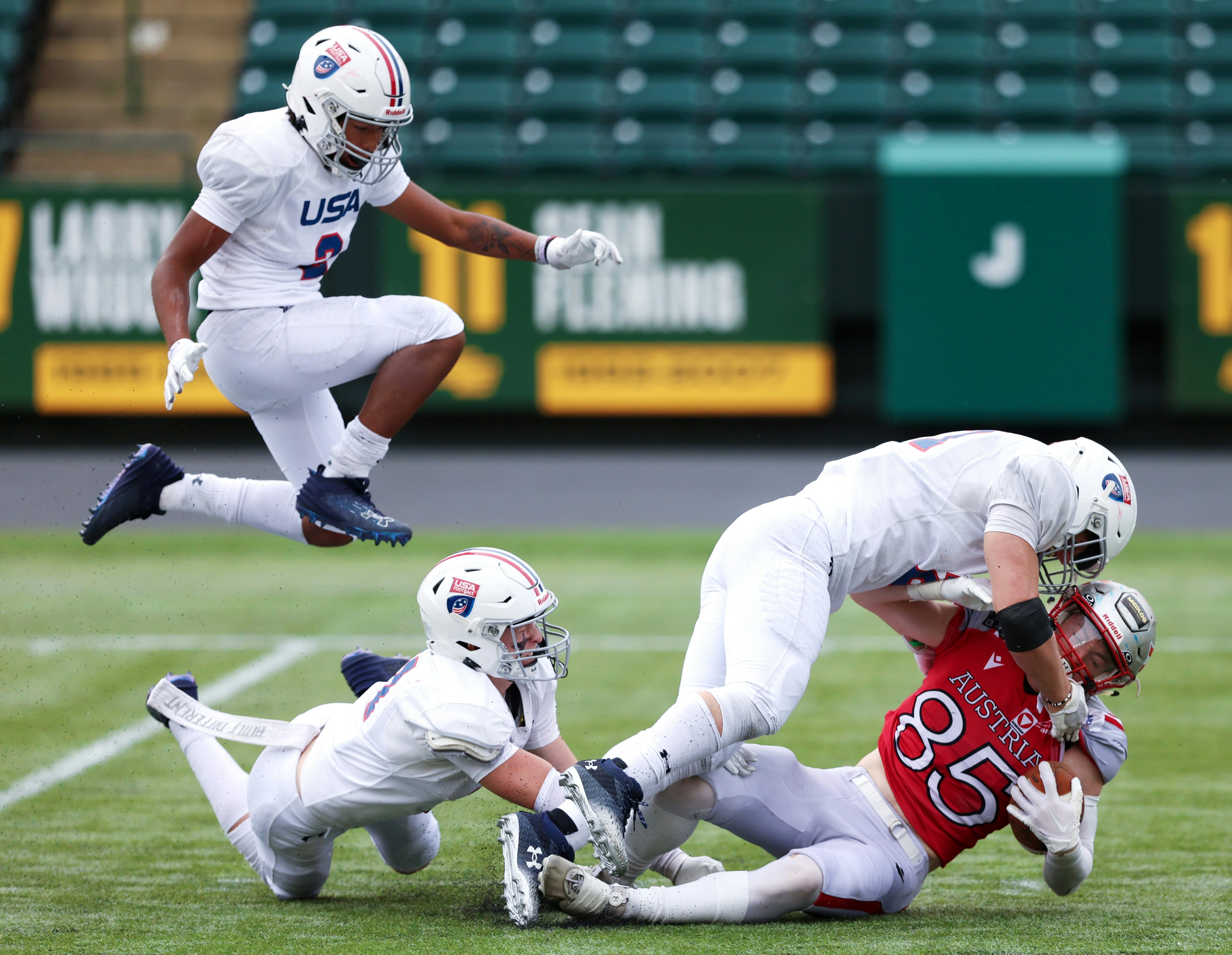 EDMONTON, AB - June 30: Team Austria's Jonas Jan Dachs-Wiesinger #85 is tackled by members of Team USA during IFAF U20 World Junior Football Championiship gameplay at Commonwealth Stadium in Edmonton, AB, Canada on June 30rd, 2024. (Photo by James Maclennan)