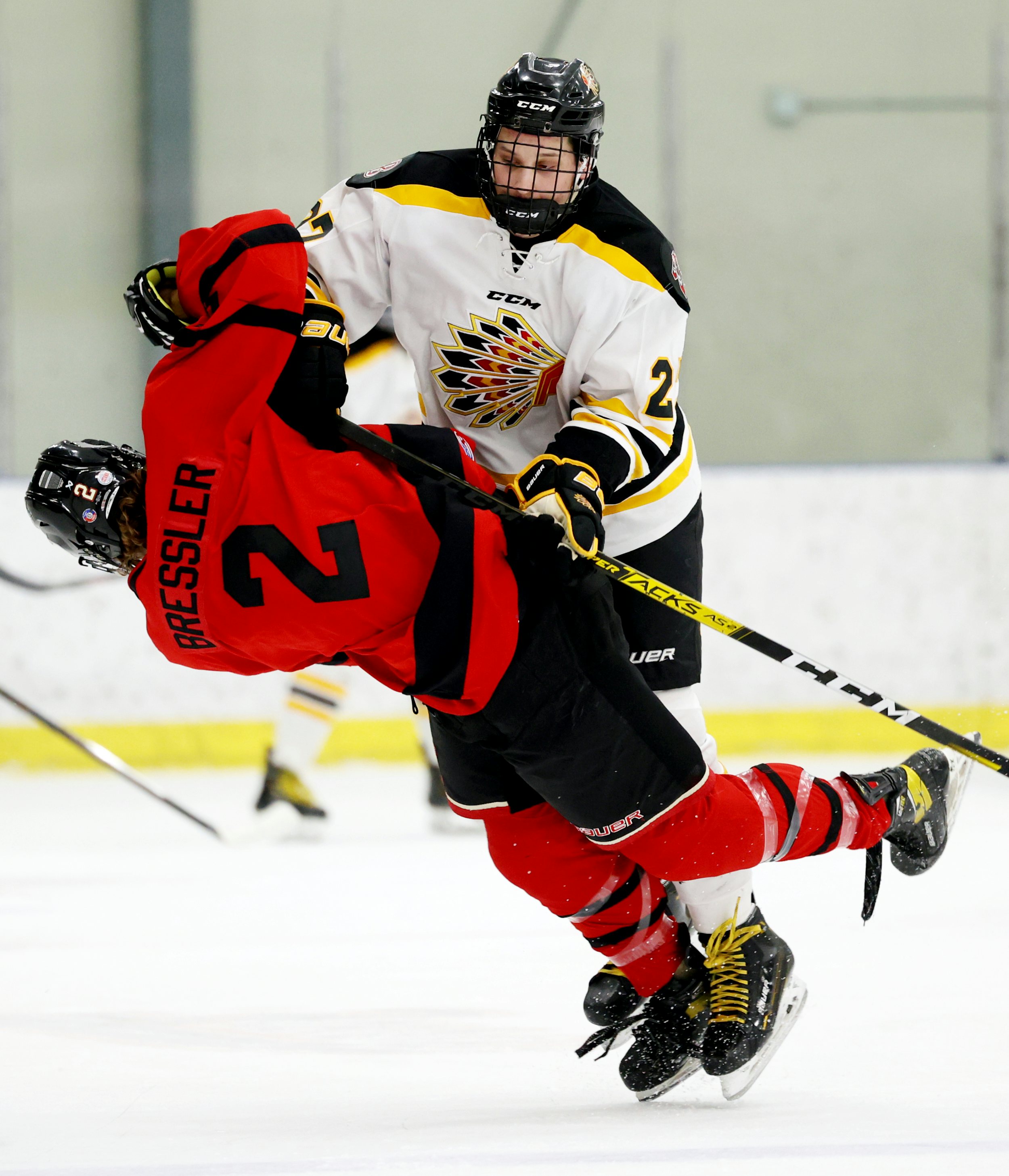 FORT SASKATCHEWAN, AB - January 5: Beaumont Chiefs defenseman Lukas Vekved #22 hits Zachary Bressler #2 of the Ft. Sask. Hawks during second period play at the DOW Centennial Centre in Fort Saskatchewan, AB on Friday, January 5th, 2024. (Photo by James Maclennan)